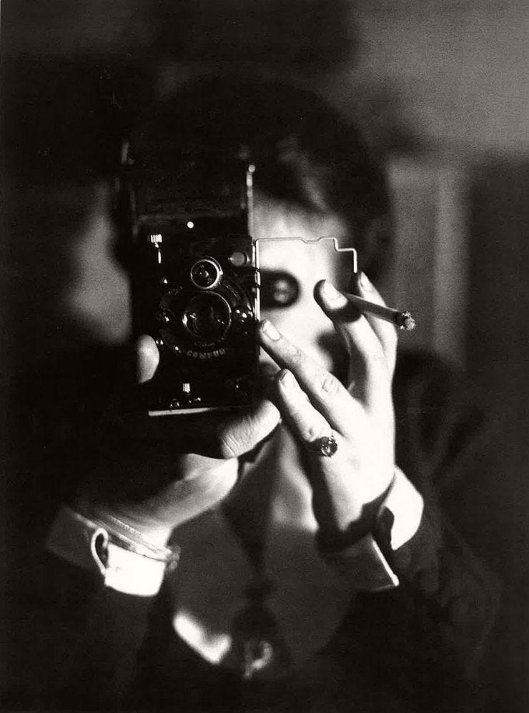 Germaine Krull, Self portrait with cigarette (Autoportrait à l'Icarette)  c. 1925.