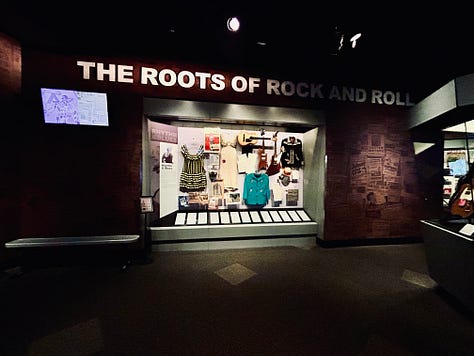 exhibits, display, guitars, case, signs
