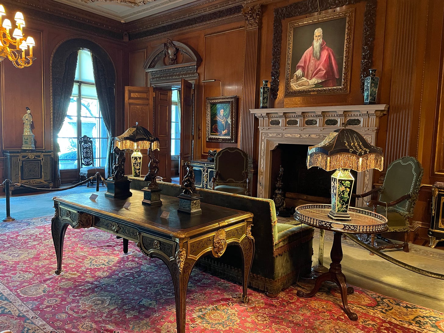 Relit paintings show well surrounded by carved wood paneling and elaborate decorative items