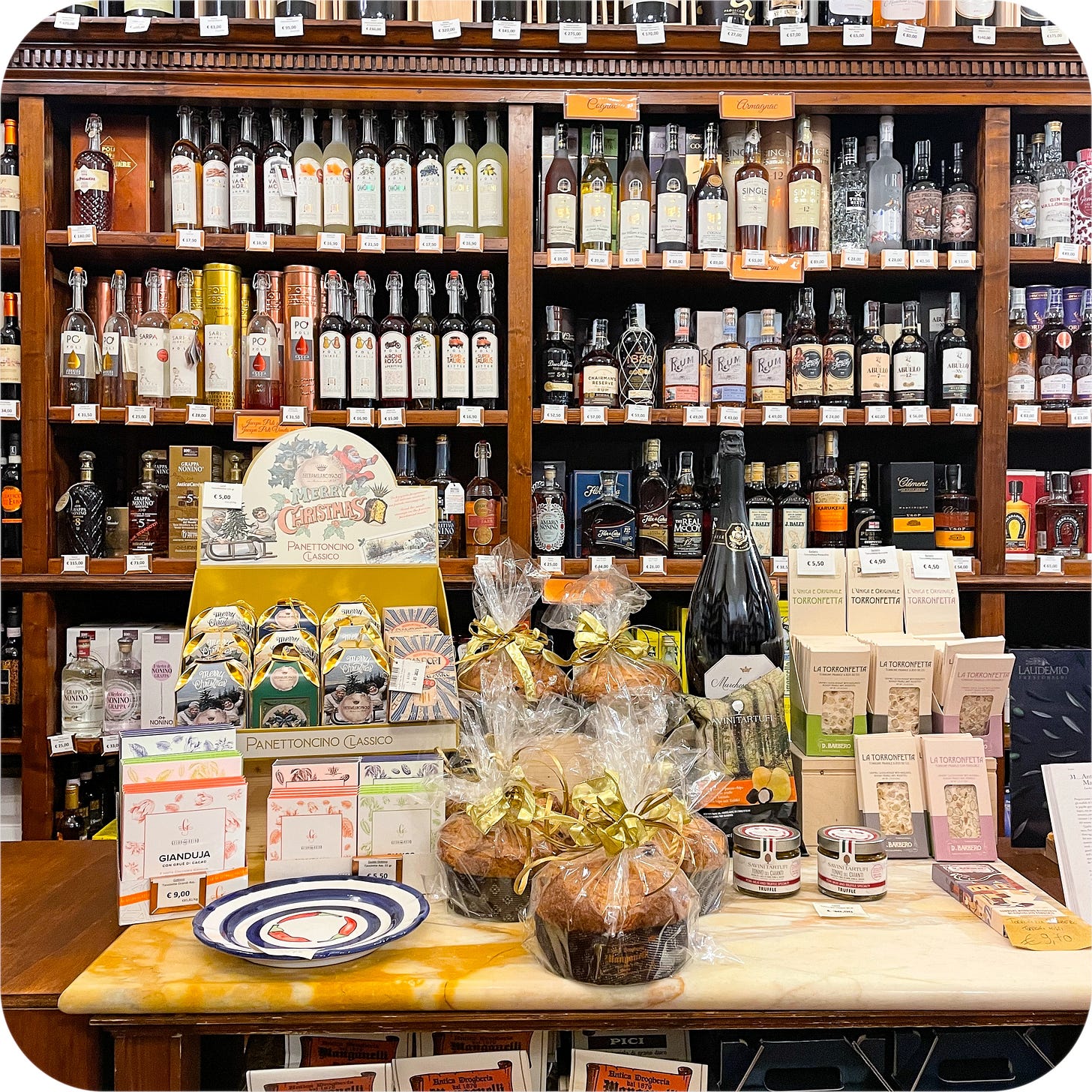 Food store with limoncello and panettone, Siena Italy