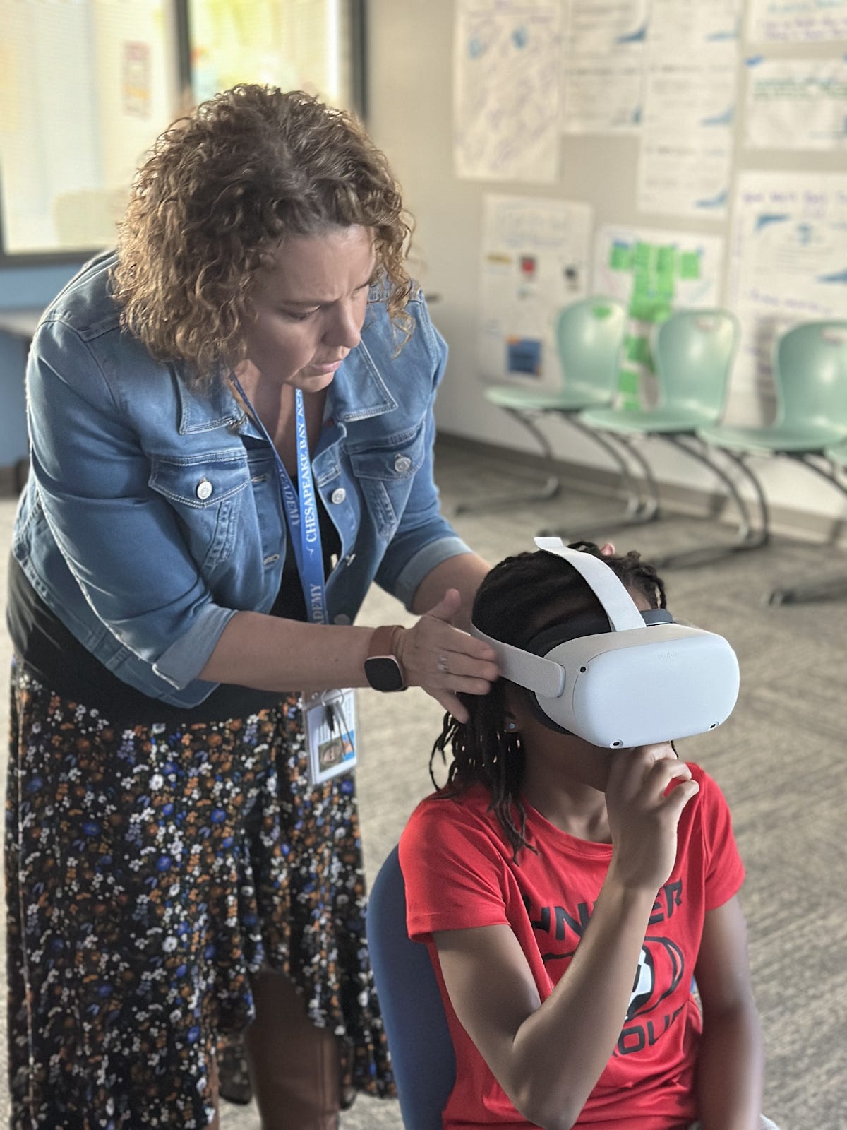 A person touching a child's head

Description automatically generated