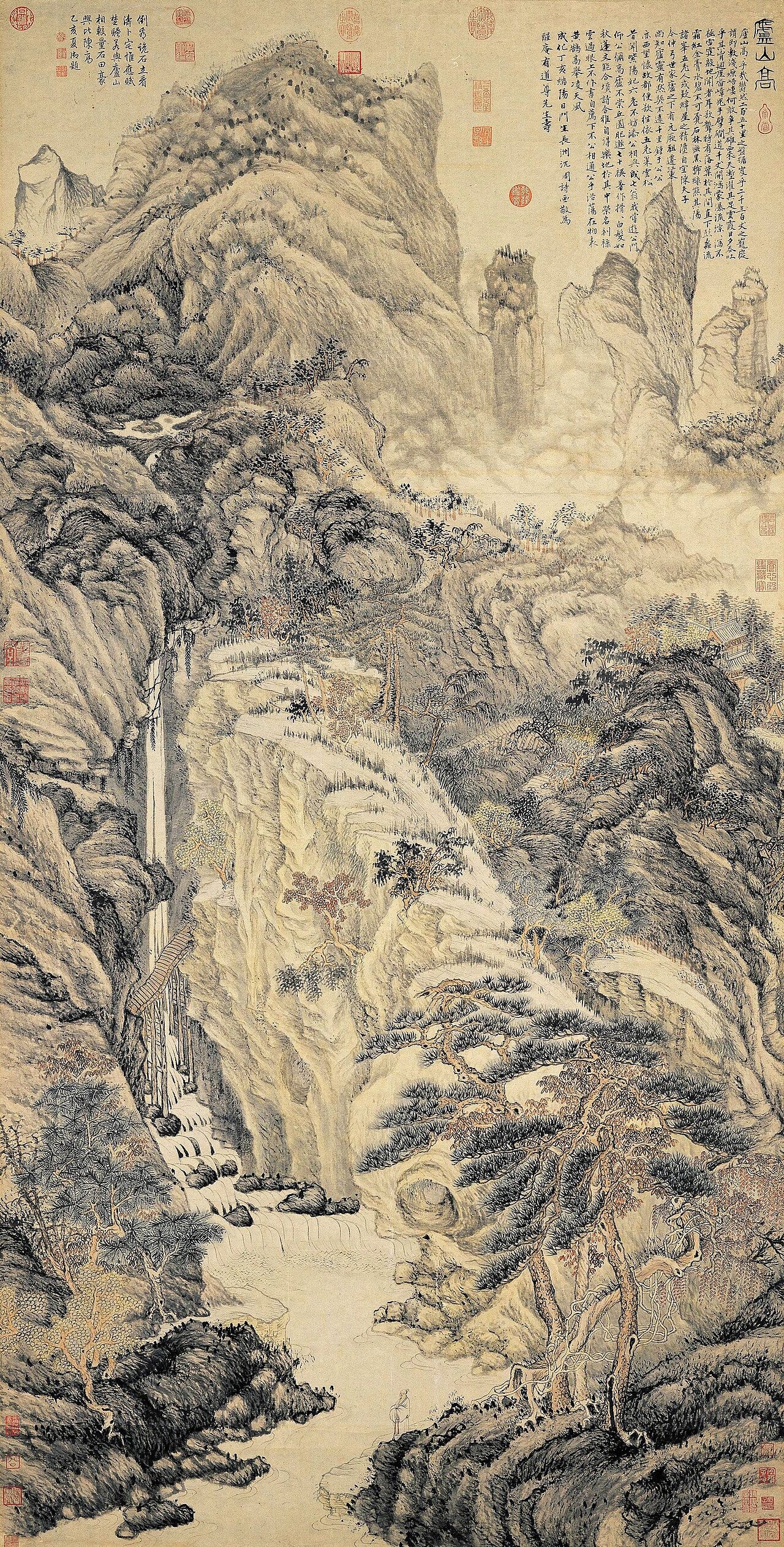 A tall ink scroll of steep, layered mountains with a thin waterfall falling down the left side and a column of calligraphy at the top