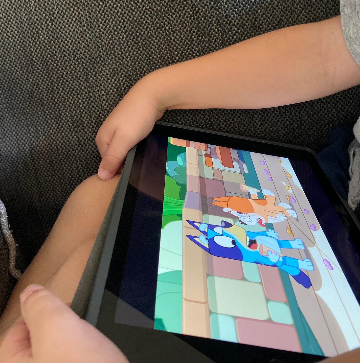 child holding iPad