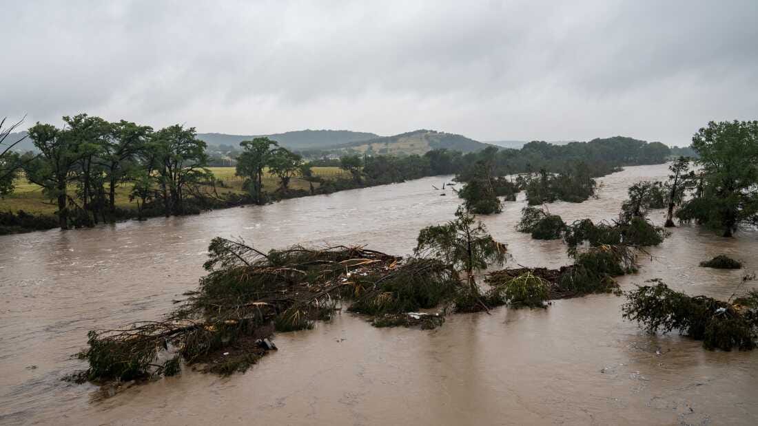 Trees emerge from flood waters along the Guadalupe River on Friday in Kerrville, Texas. Heavy rainfall caused flooding along the Guadalupe River in central Texas with dozens of fatalities reported.
