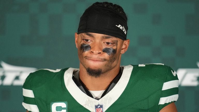 New York Jets quarterback Justin Fields (7) looks down during a press conference after an NFL football game between the Denver Broncos and the New York Jets, Sunday, Oct. 12, 2025, in London. (AP Photo/Kin Cheung)