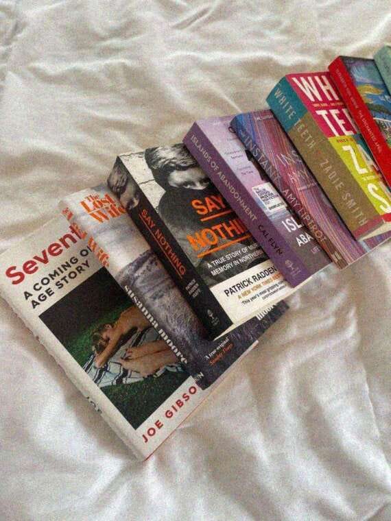 May be an image of text that says 'ISLAY WHITETEETH MИH WHITE FEETH TE ZADIE ZADIESMITH ๋ไว่ ISL CO SMITH ABA 知 Sevent Seveni STORY AGE SA NOTHI STORY NORTH TRUE TRUESTORY RADDE susanna レ MEMORY PATRICK MEN AN This 1I00 fnae GIBSO JOE'