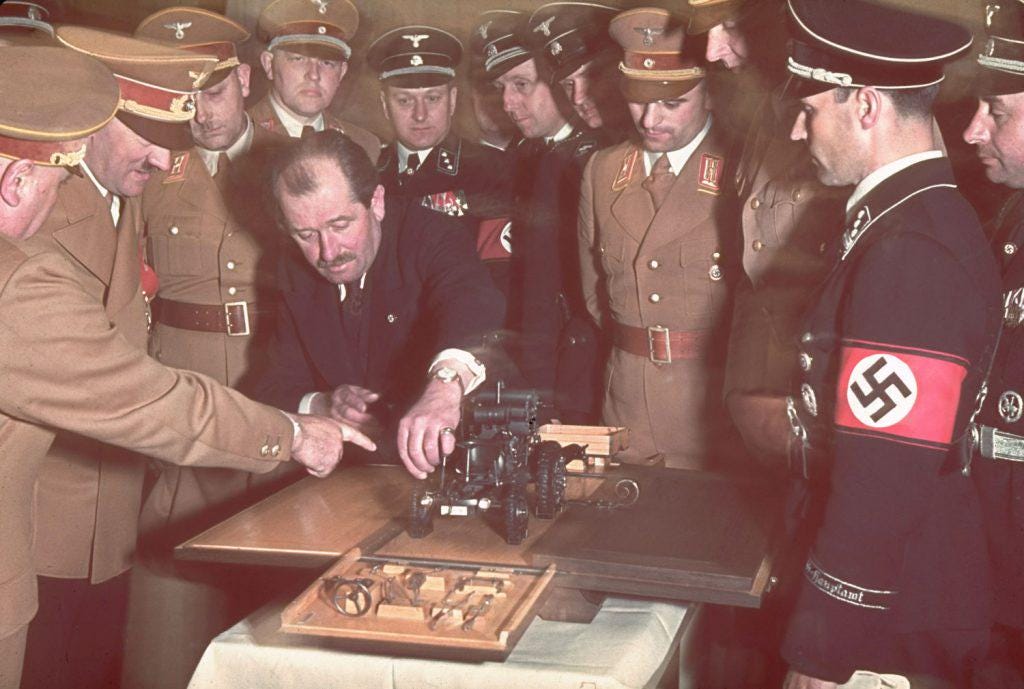 Ferdinand Porsche presents a model car to Adolf Hitler during the lavish celebrations for Hitler’s 50th birthday in Berlin, April 1939.