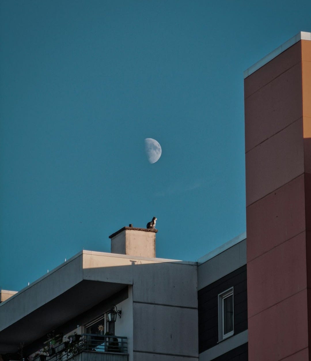 a building with a moon in the sky a building with a moon in the sky