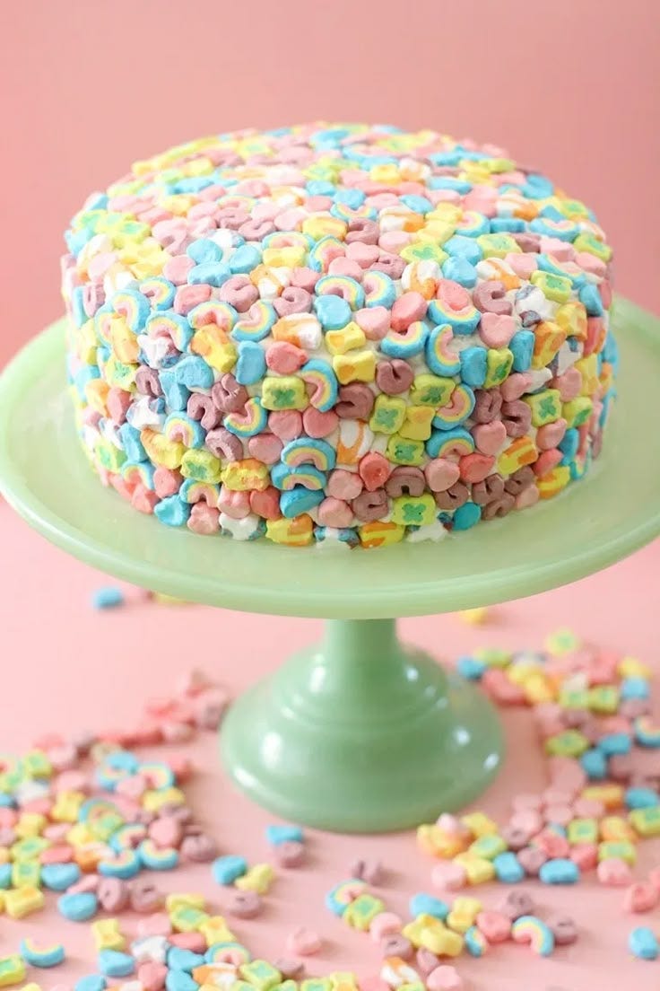 This may contain: a cake with sprinkles on it sitting on a green plate and surrounded by confetti