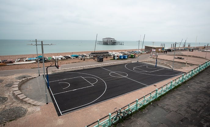 A basketball court on a beach

Description automatically generated