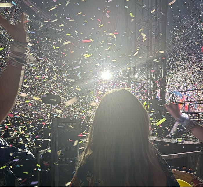 Back of child’s head staring at confetti in a dark arena