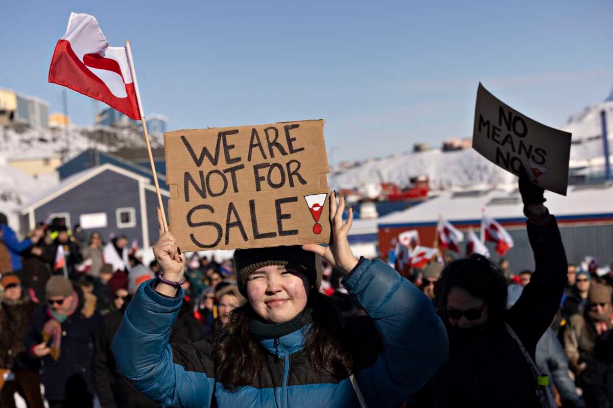 A protester holds a sign reading “We are not for sale” in front of the U.S. consulate during a demonstration in Nuuk, Greenland, on March 15, 2025.