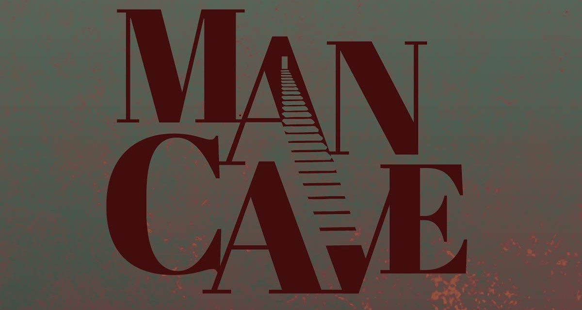 The words "Man Cave" written in all-caps dark red font. A door opens on the letter A and steps go down all the way to the letter V.