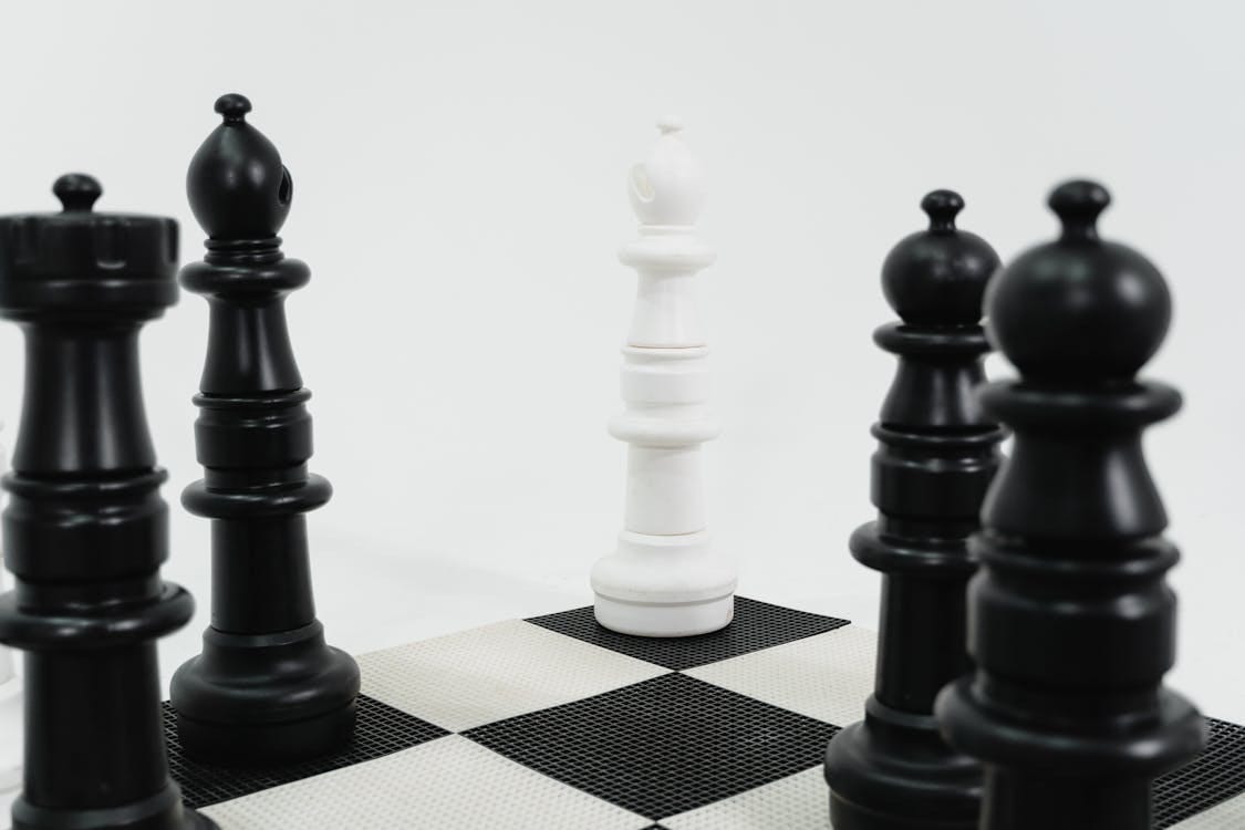 Free Close-up of chess pieces in strategic formation on a chessboard representing strategic thinking. Stock Photo
