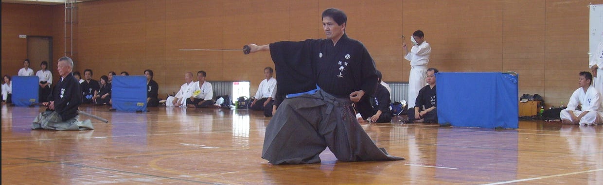 Photo of Inoue Sensei doing Iaido kata 