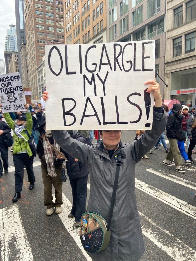 protest sign that says oligargle my balls