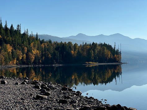 Images of Lake McDonald, left image of trees and mountains reflected on lake, middle computer with lake in background, right man carrying canoe to lake