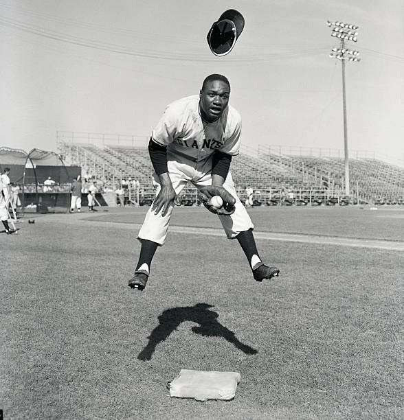 New York Giants third baseman Hank Thompson loses his baseball cap in a midair leap. New York Giants third baseman Hank Thompson loses his baseball cap in a midair leap.