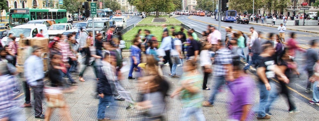 timelapse photo of people passing the street
