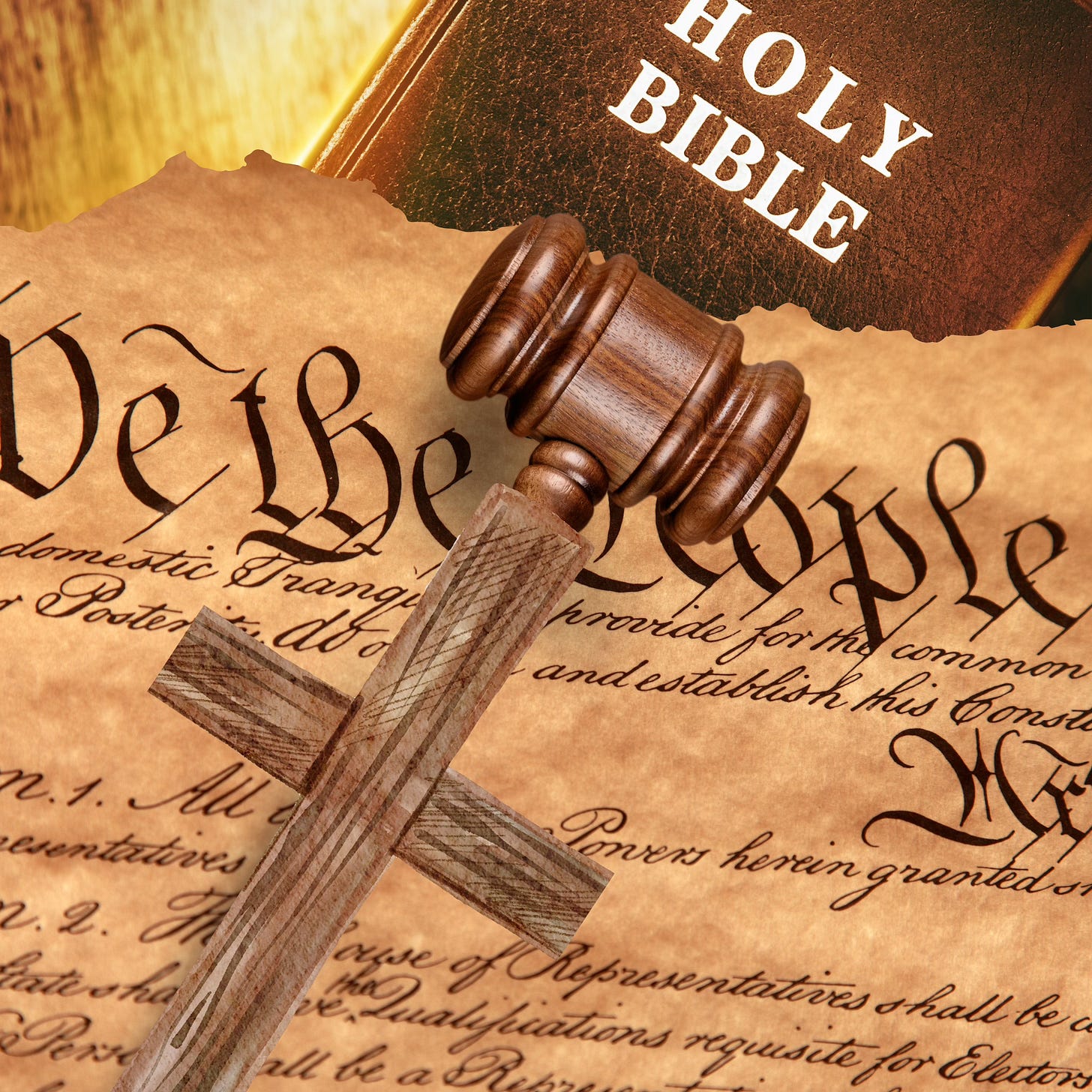 A wooden gavel with a cross for a handle sits atop a ripped copy of the US Constitution. Underneath sits a bible.
