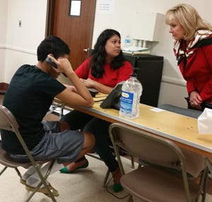 Gov. Mary Fallin talks to a caseworker and a minor being held at a temporary shelter at Fort Sill. PROVIDED PHOTO Gov. Mary Fallin talks to a caseworker and a minor being held at a temporary shelter at Fort Sill. PROVIDED PHOTO