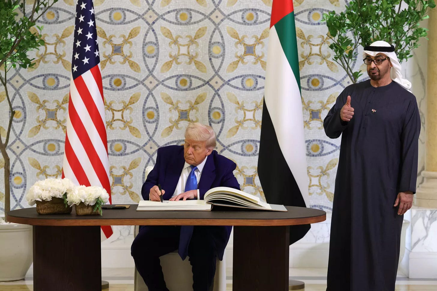 U.S. President Donald J. Trump signs the guestbook as UAE President Sheikh Mohamed bin Zayed Al Nahyan looks on. U.S. President Donald J. Trump signs the guestbook as UAE President Sheikh Mohamed bin Zayed Al Nahyan looks on.
