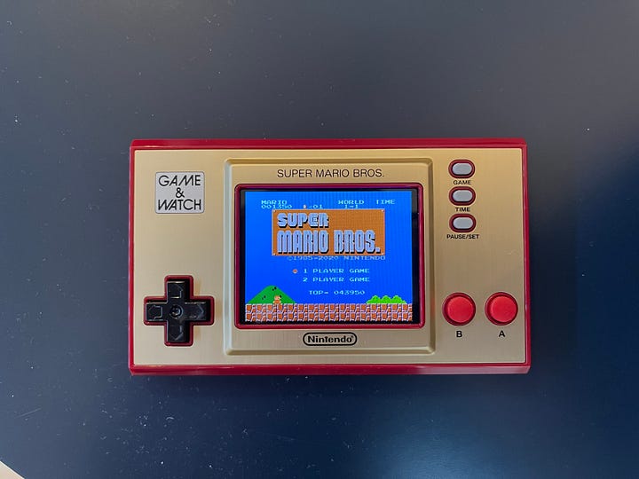 Two top-down shots of the Game & Watch: one with the starting screen of Super Mario Bros. and the second with the game Ball.