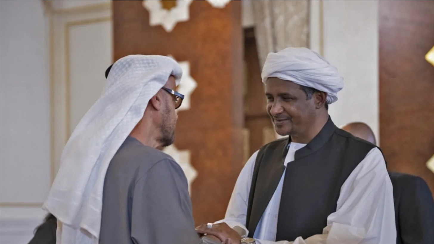 Mohamed Hamdan Dagalo “Hemeti” (R), then deputy chairman of Sudan’s Sovereign Council, pays respects to Mohammed bin Zayed Al Nahyan (L), the ruler of Abu Dhabi and president of the UAE, at the Presidential Airport in Abu Dhabi on 15 May 2022 (AFP)