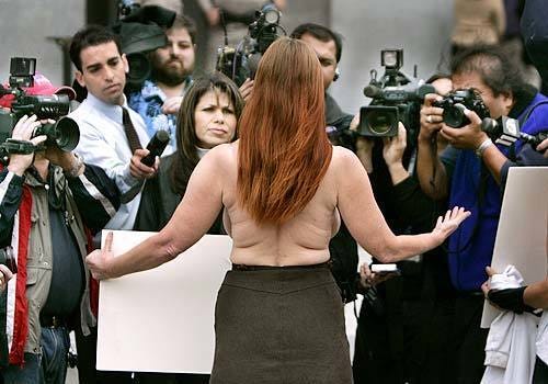 Tantra Benkso of San Francisco talks to the press on the west steps of the state capitol. She wore two political buttons taped over her nipples. Tantra Benkso of San Francisco talks to the press on the west steps of the state capitol. She wore two political buttons taped over her nipples.