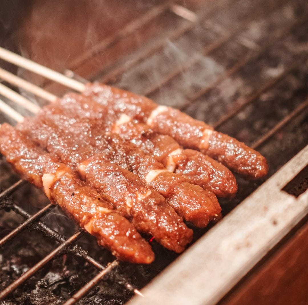 a close up of food cooking on a grill a close up of food cooking on a grill