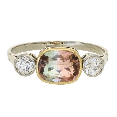 2 rings, one with a colourful green and orange stone, one sapphire, one snake 