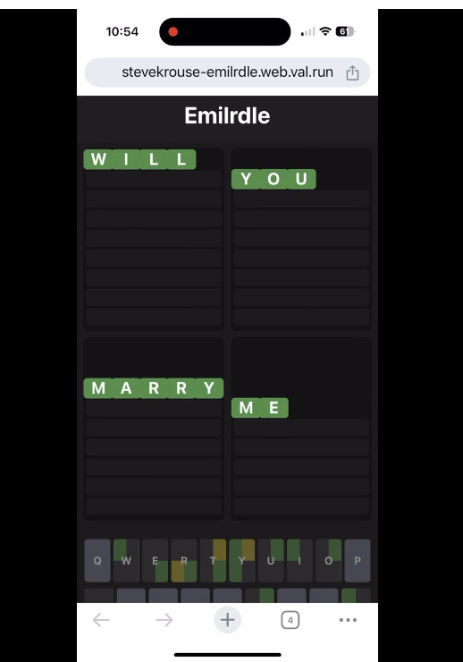 A screenshot of a custom word game called Emilrdle on a smartphone. The game interface has a dark background with green letter tiles spelling out "WILL YOU MARRY ME" across four grids. The keyboard at the bottom shows some letters in green, yellow, and gray, similar to Wordle-style mechanics. The browser URL suggests a personalized web-based game, seemingly designed as a marriage proposal.