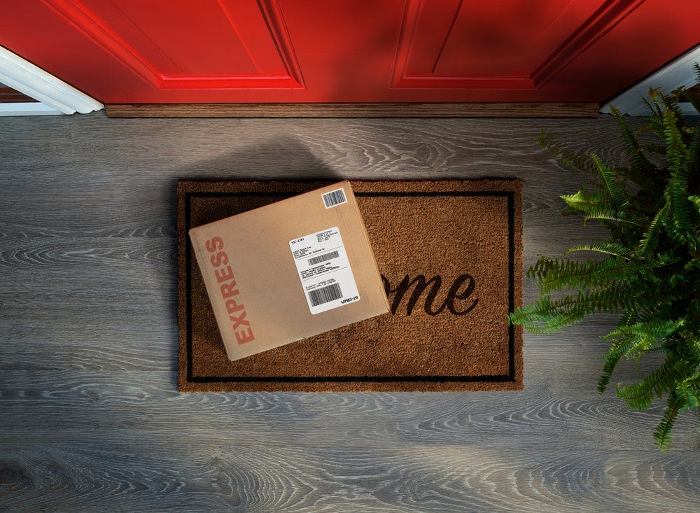 Express box on a doormat in front of a door. 