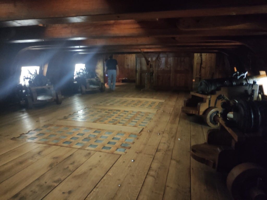 Reproduction of a gundeck with cannons on either side Reproduction of a gundeck with cannons on either side