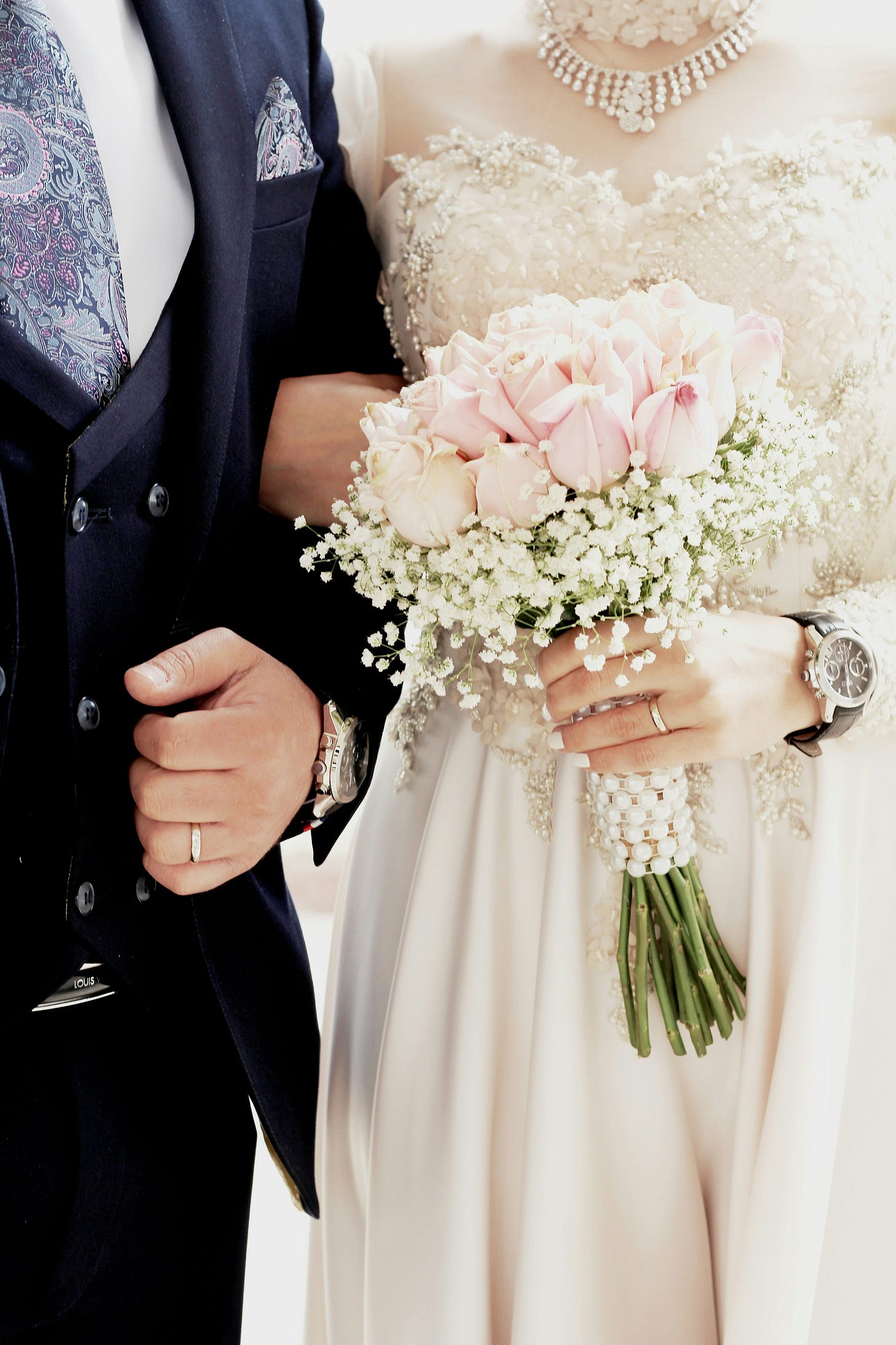 a bride and groom arm in arm