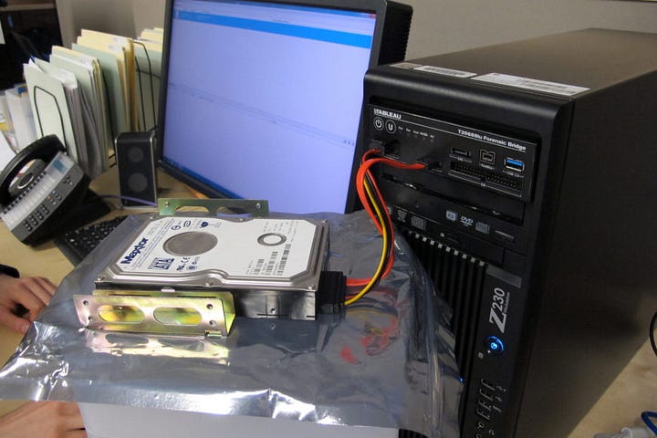 Programmer/restorer extract the hard drive of artist-provided computer, then uses a forensic bridge to back up its contents
