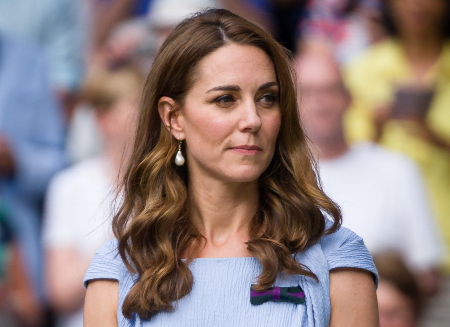 Princess Kate looking to the right in a baby blue dress