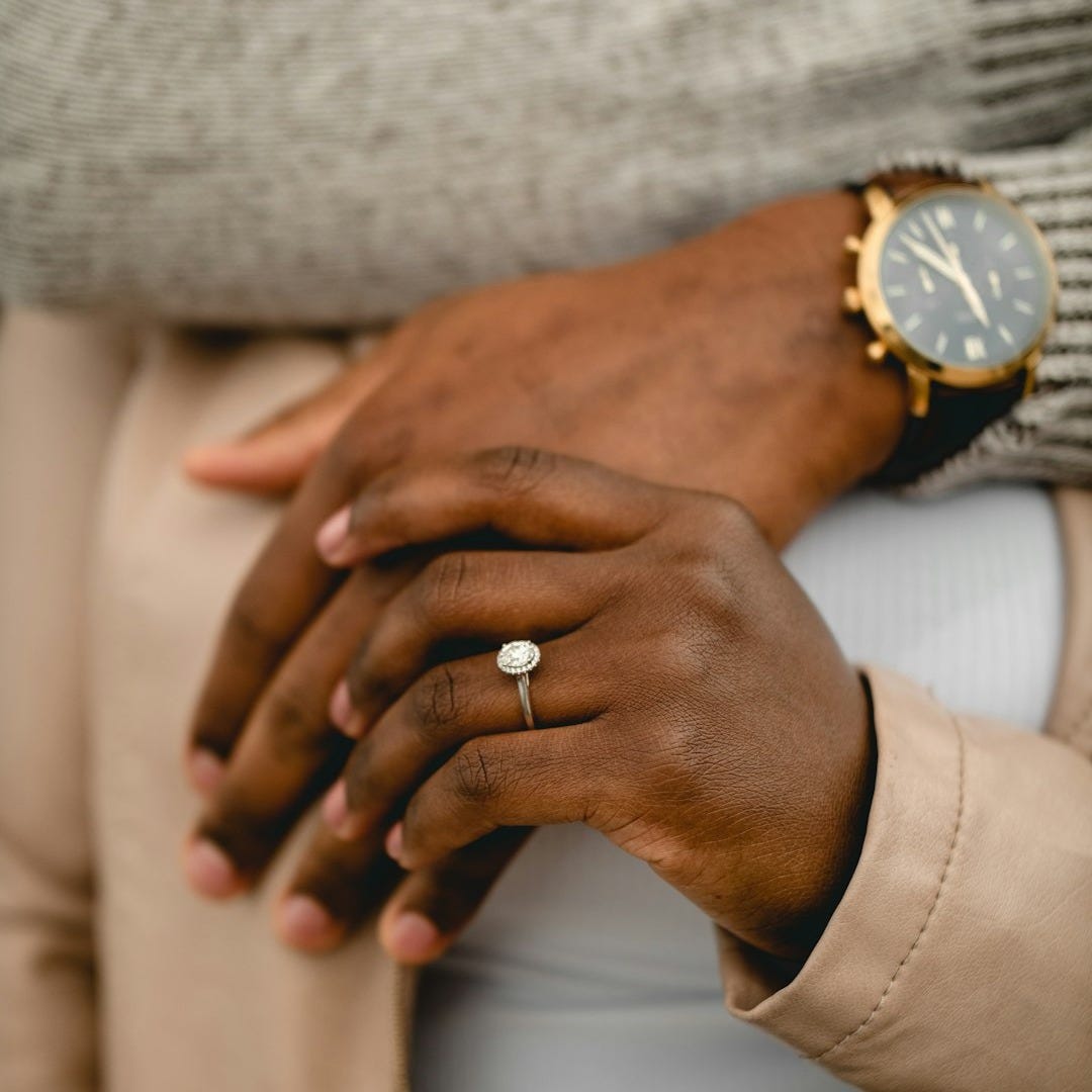 person wearing gold ring and silver ring