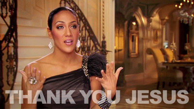 A woman in a formal dress and a luxurious gold background crosses herself and says Thank You Jesus