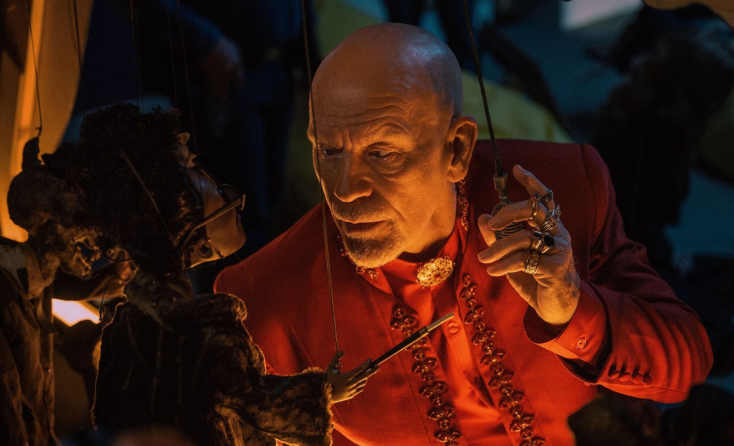 Image may contain John Malkovich Adult Person Accessories Jewelry Necklace Face Head Photography and Portrait