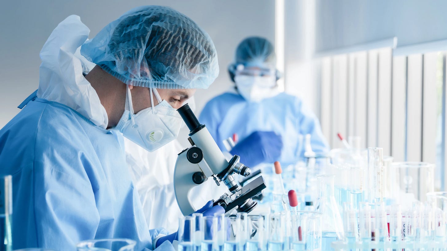 Biochemical,Research,Scientist,Team,Working,With,Microscope,For,Coronavirus,Vaccine Biochemical,Research,Scientist,Team,Working,With,Microscope,For,Coronavirus,Vaccine