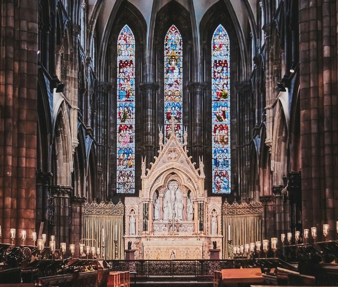 a large cathedral with stained glass windows and pews a large cathedral with stained glass windows and pews