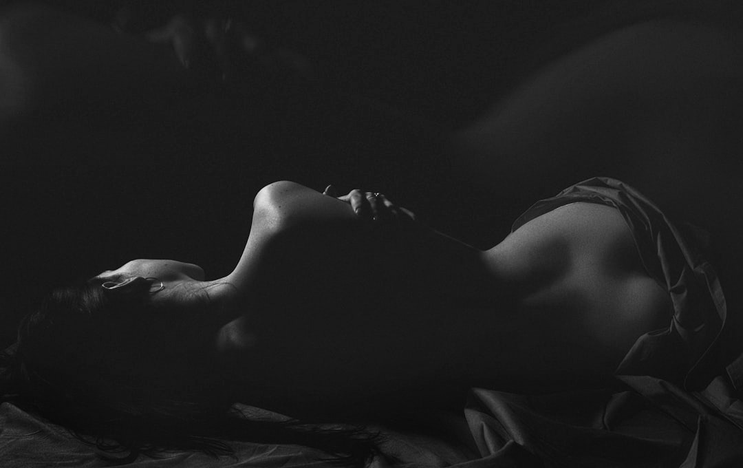 a woman in a red dress laying on a bed