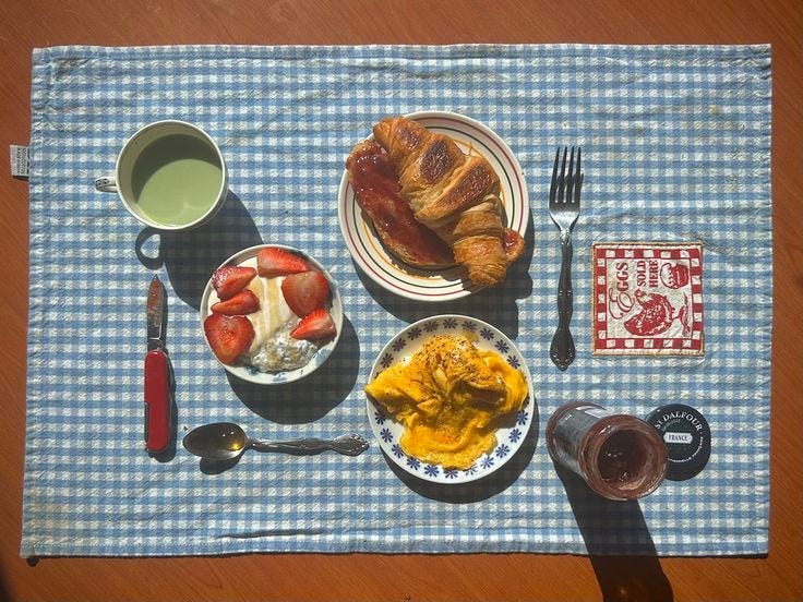This may contain: a table topped with plates and bowls of food