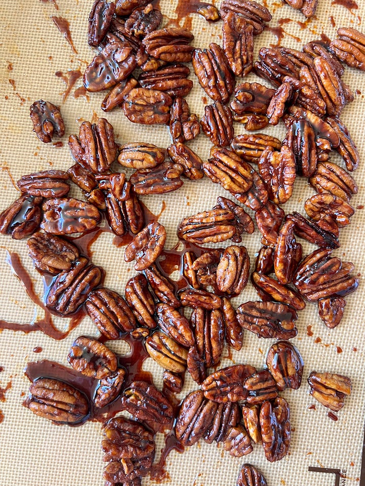 Date syrup in an off white bowl and pecans roasted with date syrup