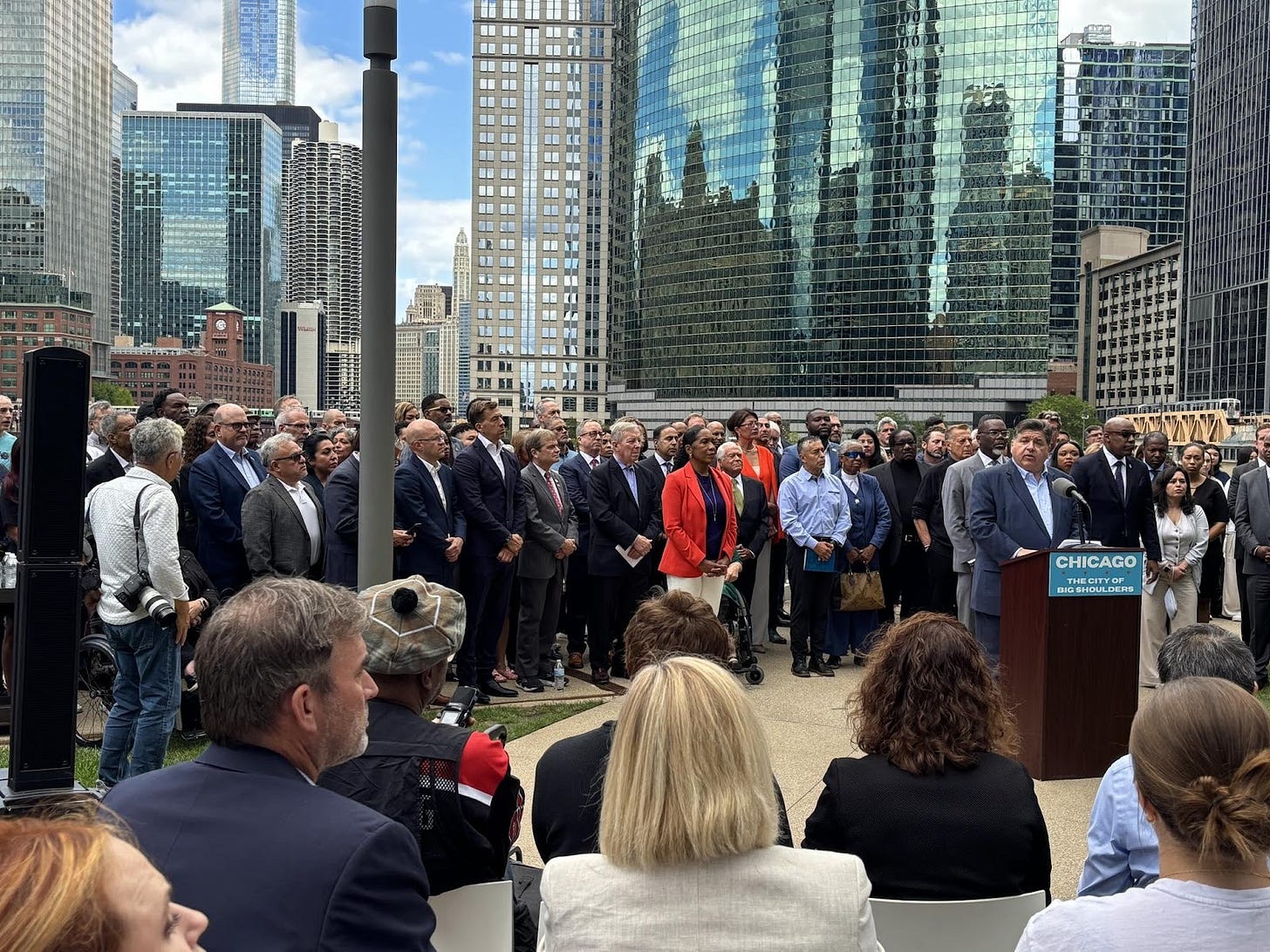 May be an image of 4 people, crowd and text