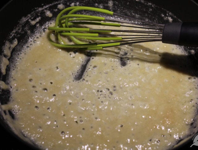 Continue whisking the roux for a minute or two to thoroughly cook the flour while being careful not to burn the mixture. Tiny bubbles should appear. Continue whisking the roux for a minute or two to thoroughly cook the flour while being careful not to burn the mixture. Tiny bubbles should appear.