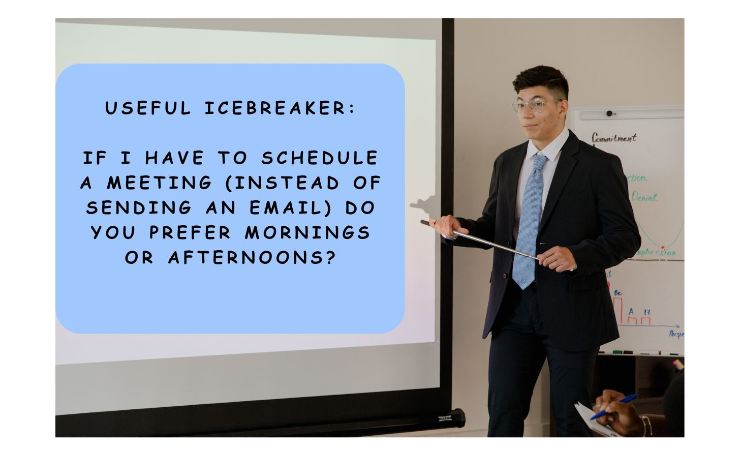 A corporate executive points to a whiteboard that says Useful Icebreaker: If I have to schedule a meeting (instead of sending an email) do you prefer mornings or afternoons?
