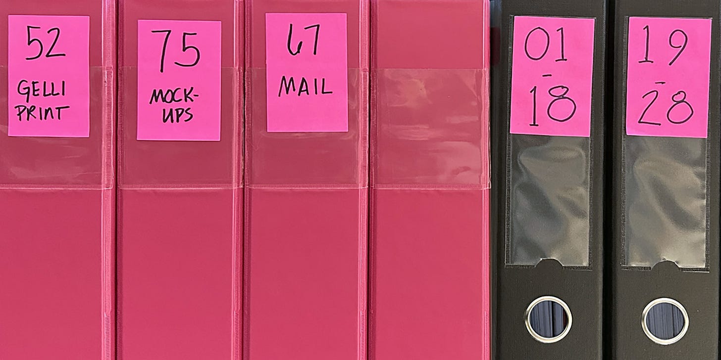 Header image: five pink binders next to three black binders with neon pink labels. One of then says 52 Gelli Print.