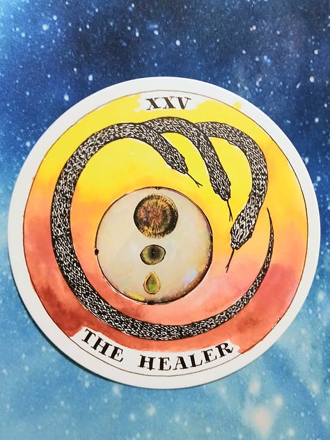 Wild Unknown Archetype cards, (The Mask, & The Healer) and crystals on a starry blue background